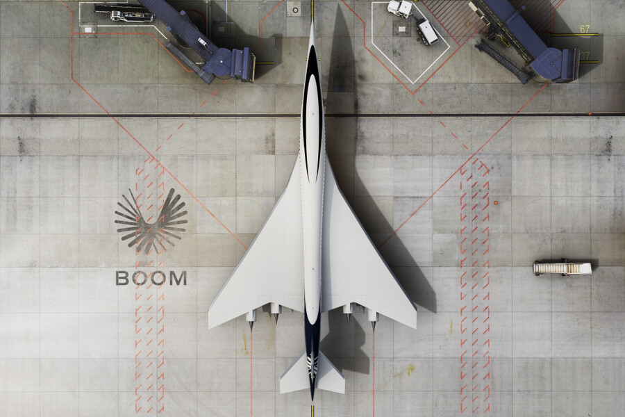 Aerial view of a Boom Supersonic Overture airliner on the ground at an airport terminal