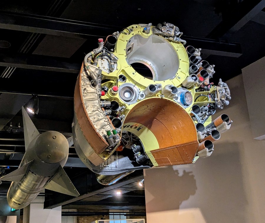 The exposed nose cone section of a large Polaris missile. It has a copper coloured curved slot to hold an atomic warhead and then a complex network of tubes for launching decoys.