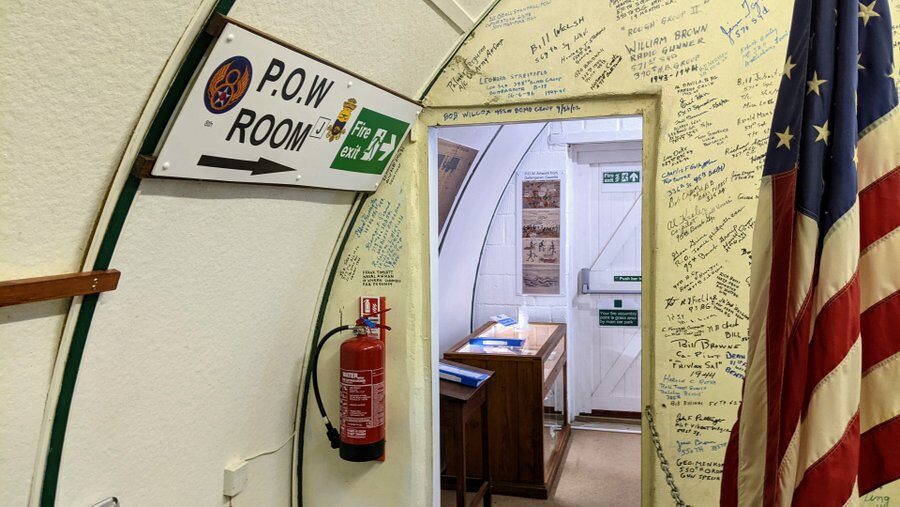 Doorway and sign pointing to the POW room