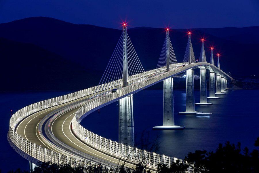 Night time image of the Illuminated Peljesac bridge crossing a dark sea