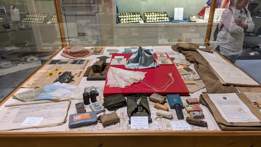 A display case full of small personal artefacts from veterans