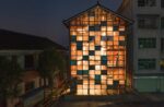 A wooden building with a wall full of illuminated panels