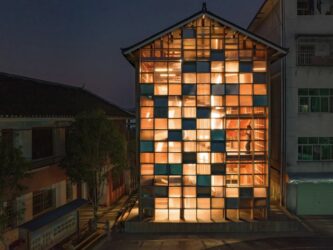 A wooden building with a wall full of illuminated panels