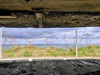 A view of the sea through a slit in the concrete observation bunker