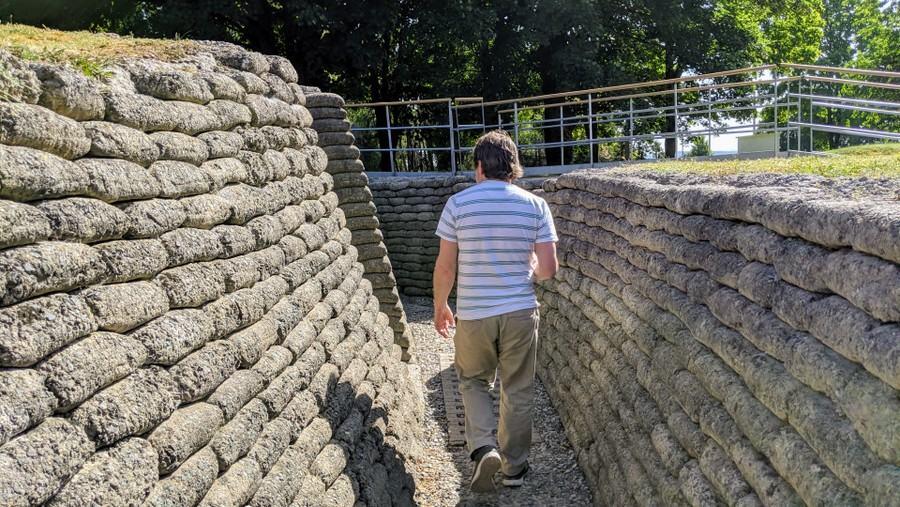 A visitor walks along a preserved Canadian trench at Vimy Ridge