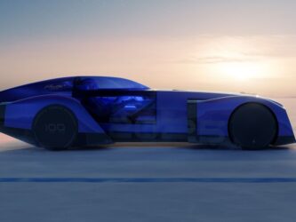 Sleek blue car with a sunset behind it