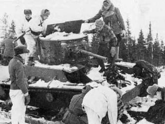 Finnish soldier on a wrecked Soviet T-26 tank