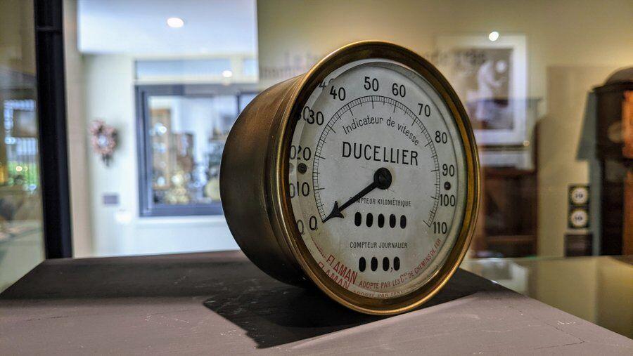 A large brass speedometer