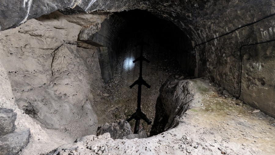 A black pipe laid up the rubble in one of the sloped gun shafts, representing an HDP multi-chamber gun. It is shaped like the skeleton of a fish (herring bone) with pairs of short stubby pipes coming off the main pipe at regular intervals. It actually looks like a long length of black PVC toilet drainage pipe! (It could be, that's what the museum used!)