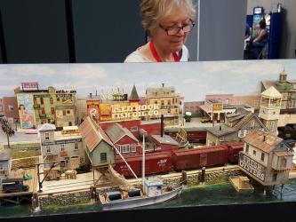 Woman looking at a model railway layout