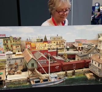 Woman looking at a model railway layout