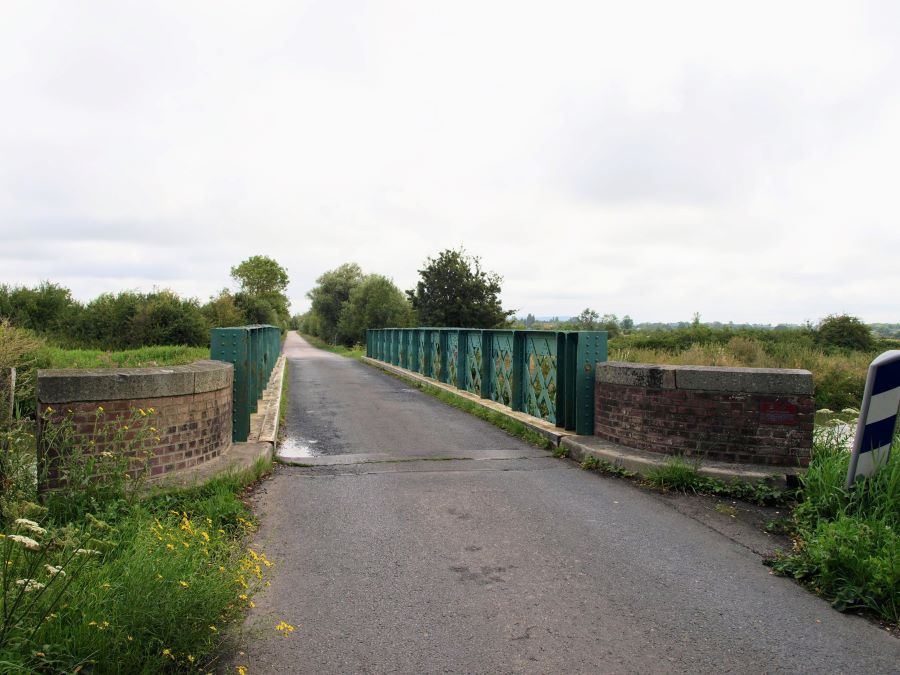 A small road bridge with green steel railings