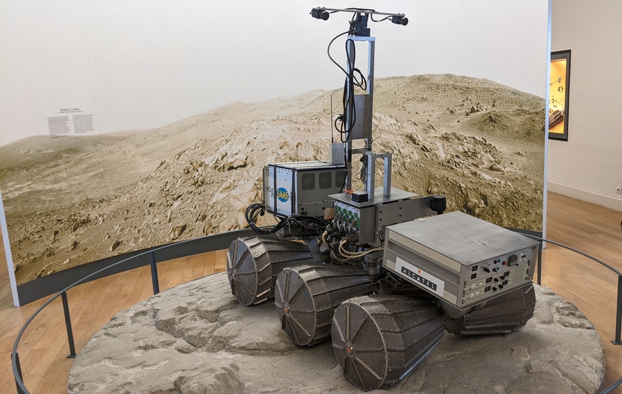 A six-wheeled rover set on what looks like a lunar surface.