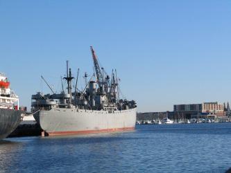 Grey cargo ship on a bright sunny day. The SS John W. Brown WW2 Liberty ship in Baltimore.