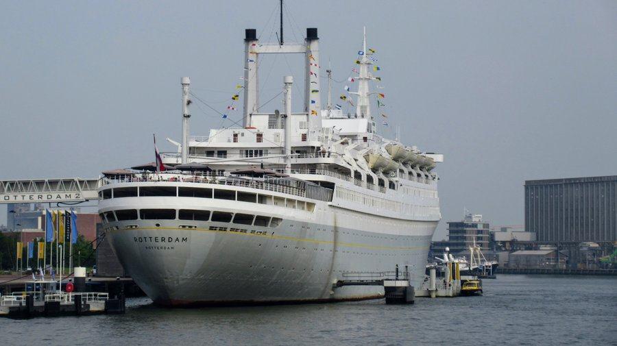 Grey & white hulled classic cruise ship moored alongside