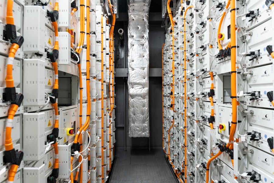 The passageway between two banks of batteries linked together by thick orange cables