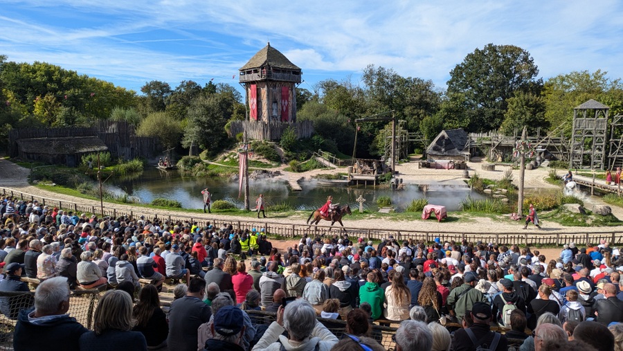 Audience looks down on a small 9th century village by a river