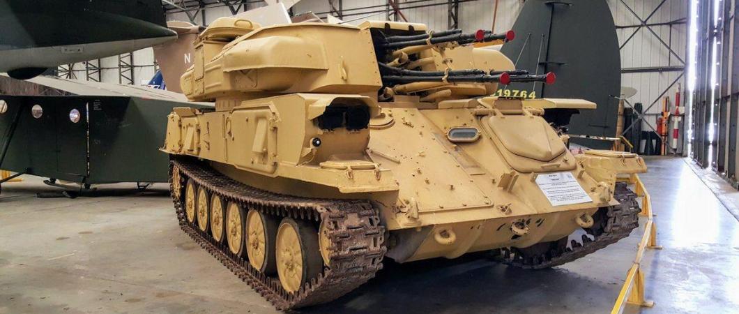 4-barreld light tank in light brown desert camouflage