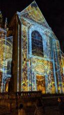 Colourful projection on the front wall of Le Mans cathedral