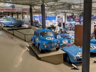 Post-war race cars on display, mostly painted blue