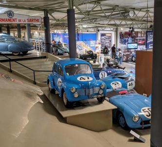 Post-war race cars on display, mostly painted blue