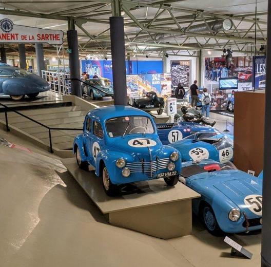 Post-war race cars on display, mostly painted blue