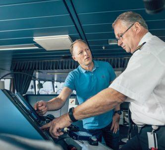 Two officers in discussion looking at a screen