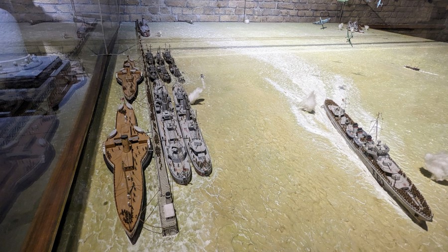 Scake model scene of Stukas attacking ships lined up alongside the mole at Dunkirk