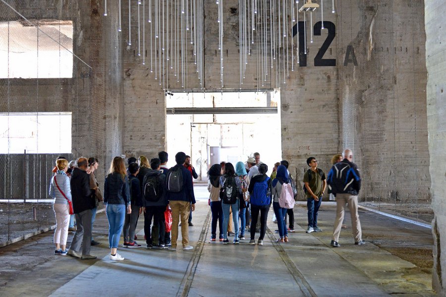 A group of visitors are guided inside the submarine base