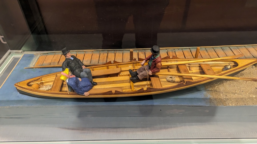 Model of a Thames boatmen at the jetty with a Victorian couple on board