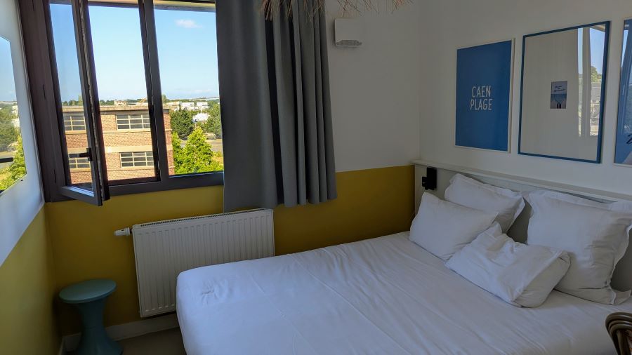 A small room with a double bed
