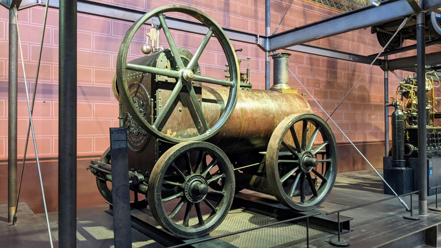 What looks like a small traction engine, but it is not self-powered. It is designed to be towed by horses.