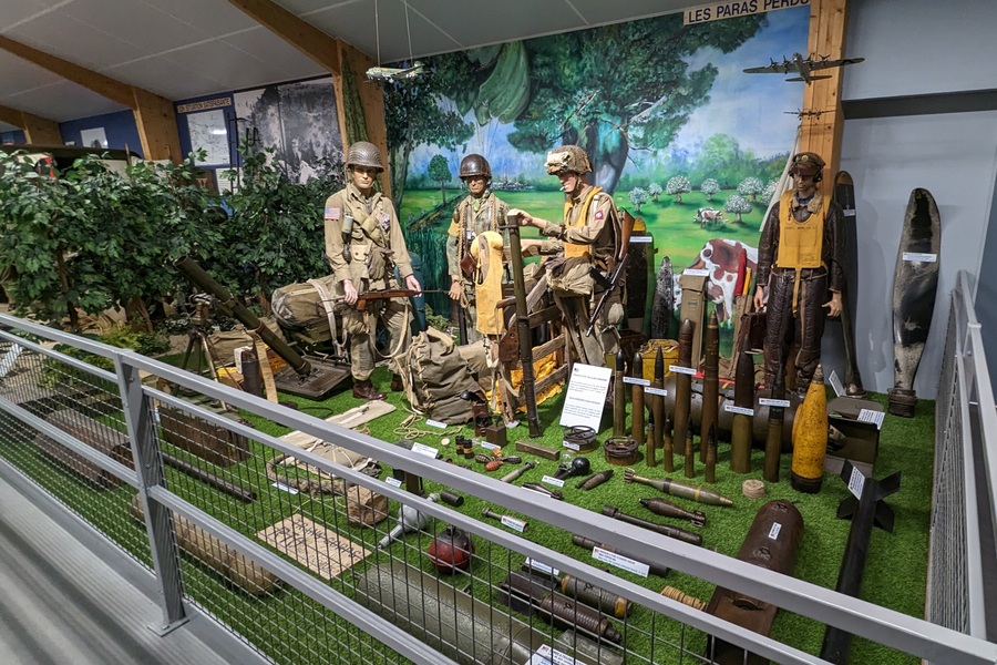 Diorama scene with US soldiers surrounded by a collection of the weapons and equipment they would have at their disposal