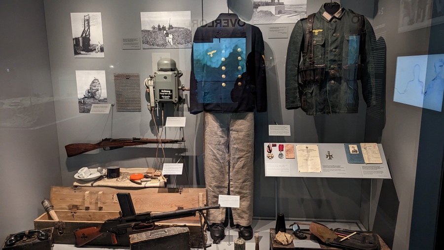 A display cabinet with German uniforms and equipment