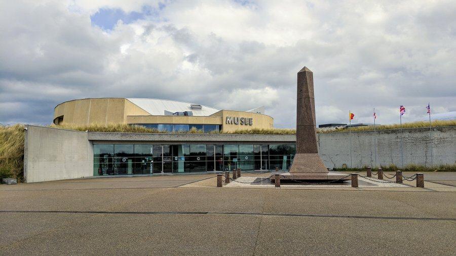 The front of the Utah Beach Museum with a tall monument in front