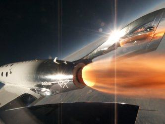Spaceship with rocket burning on the edge of space