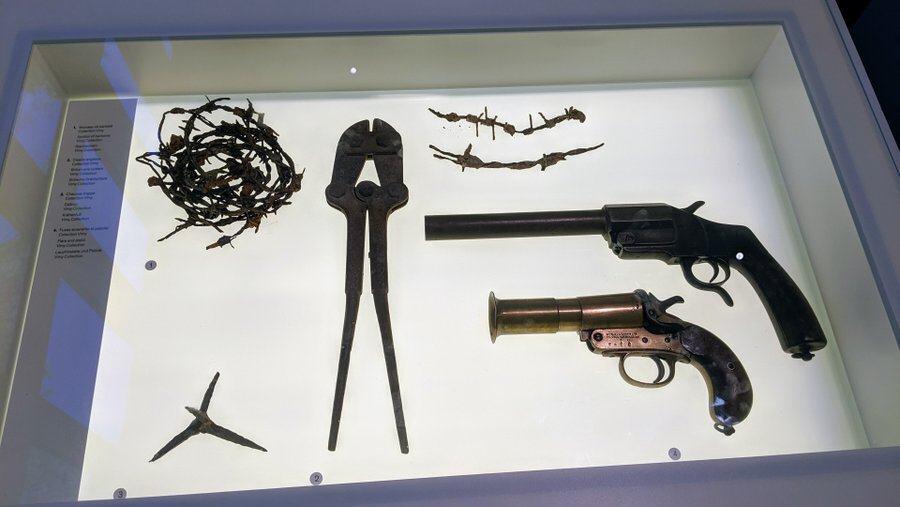 A Very pistol & barbed wire in display case