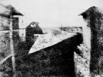 A barely discernible b/w image of some courtyard walls