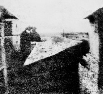 A barely discernible b/w image of some courtyard walls