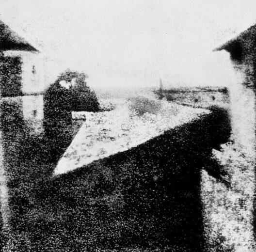 A barely discernible b/w image of some courtyard walls