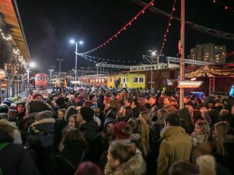 Music gig audience dress warmly with historic locomotives behind