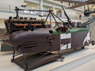 Brown painted fuselage of a WW1 biplane displayed in the Air & Space Museum, Le Bourget