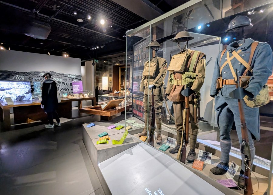 Glass cabinet with a row of WW1 uniforms on display