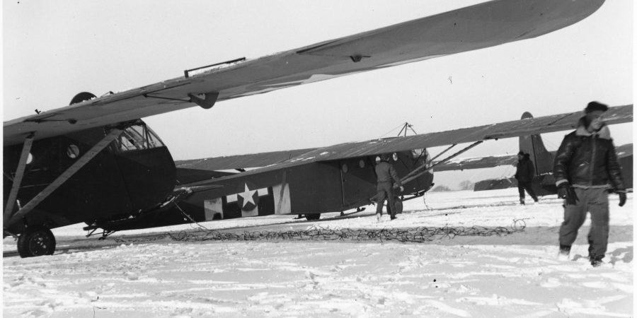 A pair of US Army Waco gliders in a snowy field