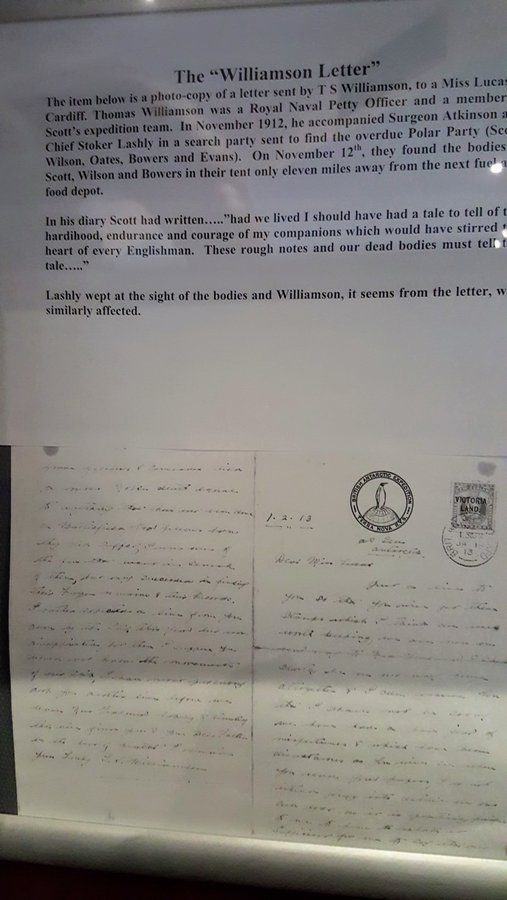 An annotated hand-written letter displayed behind reflective glass