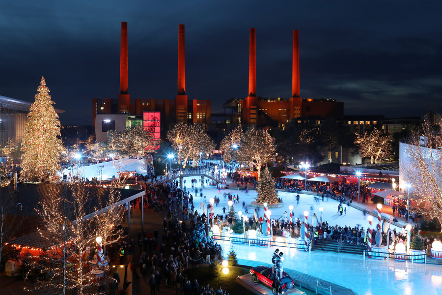 Illuminated winter festival with stalls and ice-skating