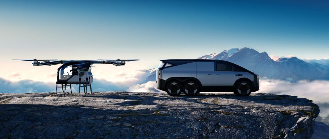 AI rendered image of a small multi-rotor eVTOL and a futuristic silver six-wheeled vehicle on a mountain ledge