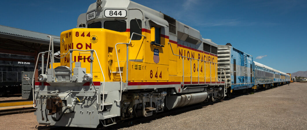 A yellow Pacific Union diesel-electric locomotive waits by the Nevada Stat Railroad Museum station platform
