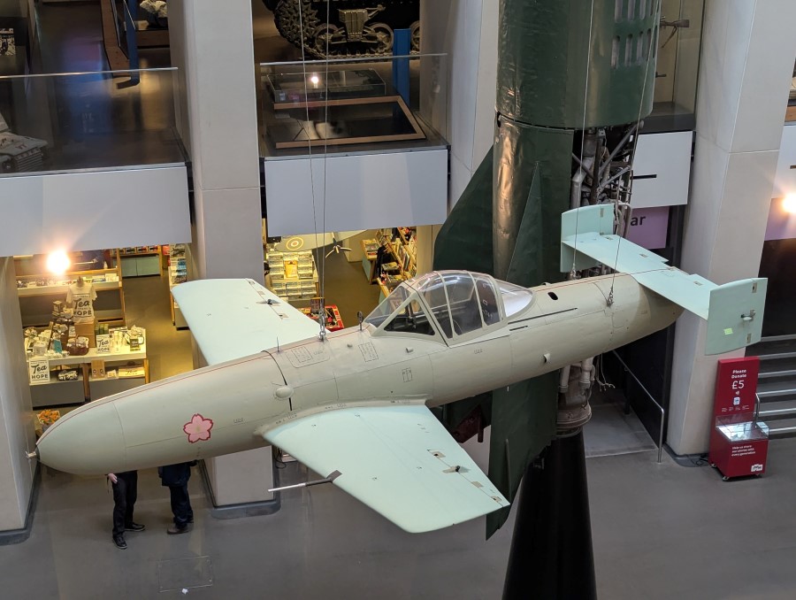 Grey rocket powered aircraft suspended in the IWM London atrium