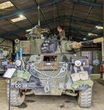 Teenage boy on top of an armoured car